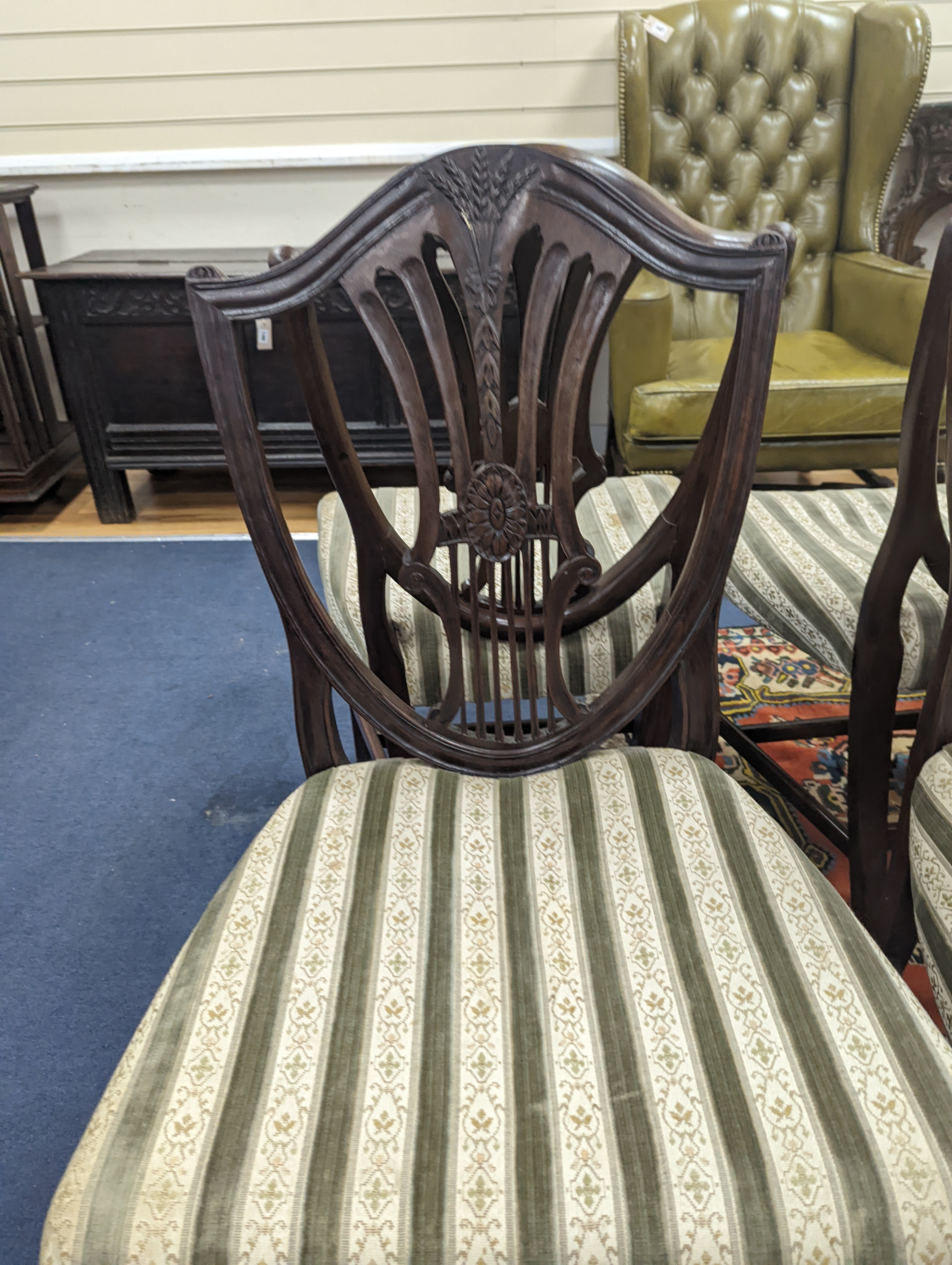 A set of six Sheraton style mahogany dining chairs with shield backs on square tapered legs